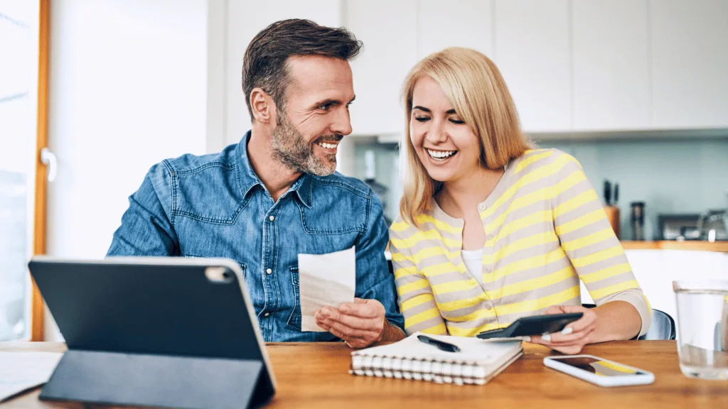 Couple looking at finances and a computer screen.