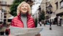 Retired female with a map whilst travelling in a new city.