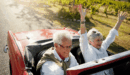 Retired couple in a convertible car on holidays.