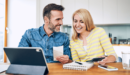 Couple looking at finances and a computer screen.